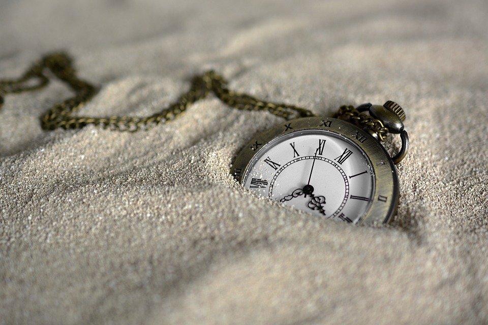 pocketwatch in sand representing the passage of time